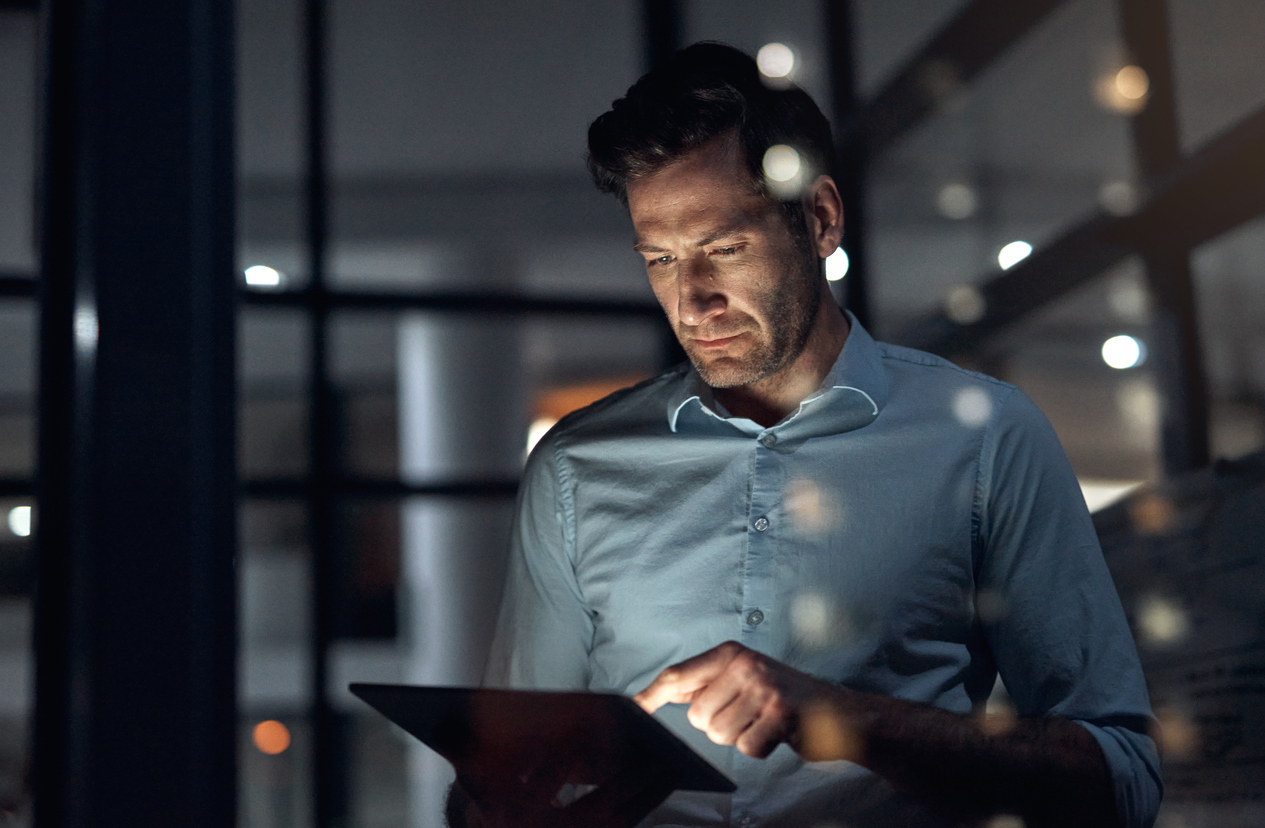 Business leader reviewing public cloud infrastructure management on a tablet, demonstrating transparent IT governance and data portability