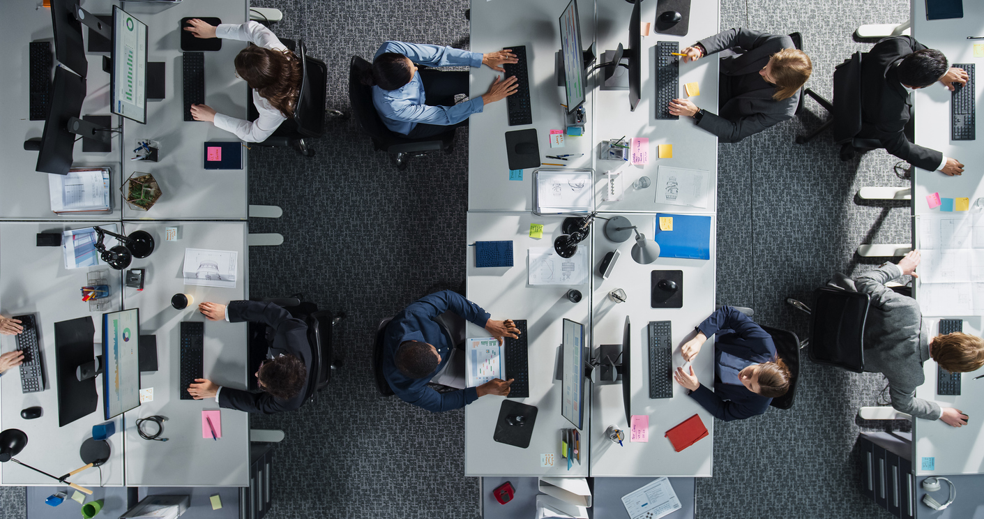 Business team working productively on laptops in a modern office, illustrating a seamless IT provider transition without downtime.