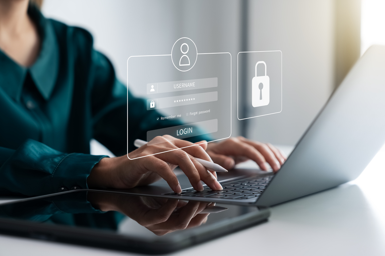 Business executive using a laptop securely in a modern office following a Microsoft 365 permission review.